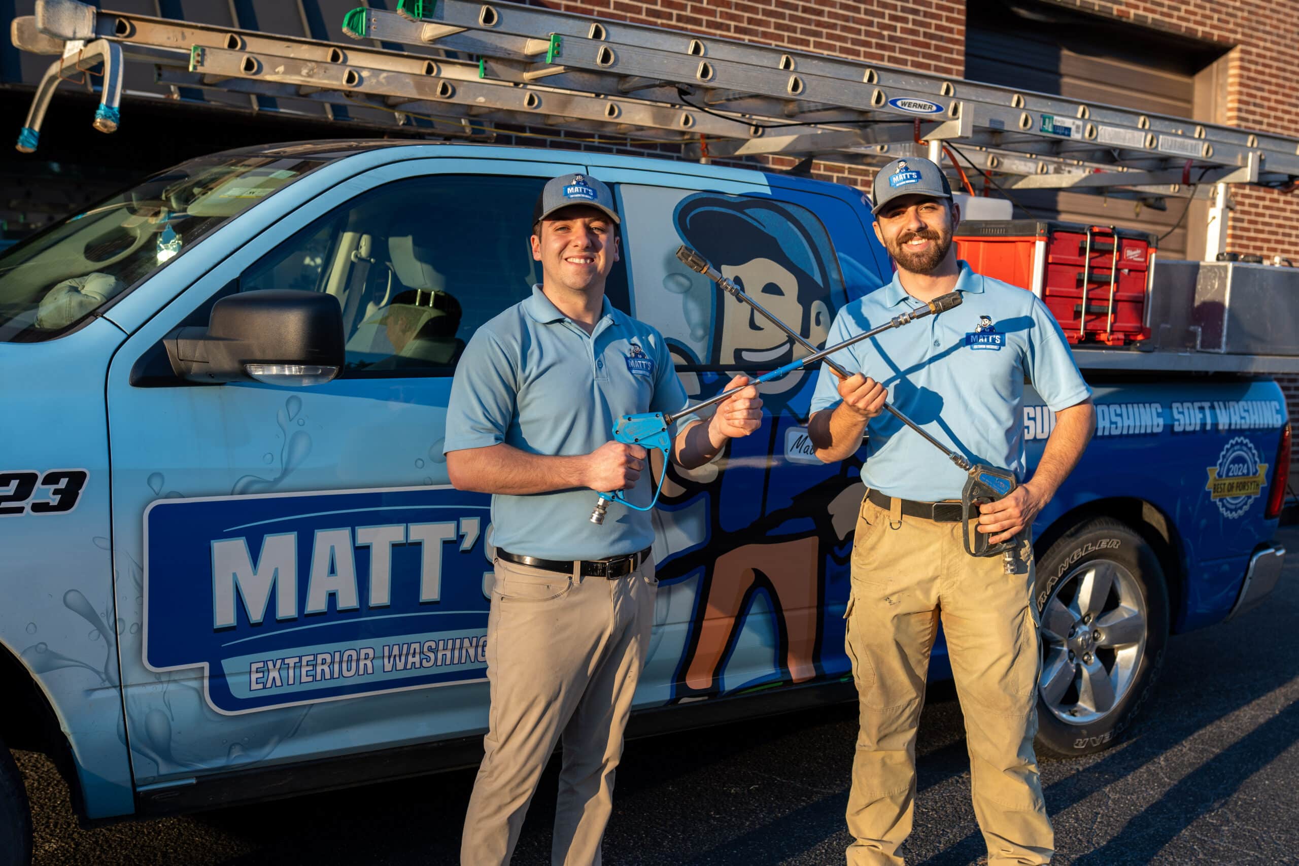 Matt and Hayden in front of company truck